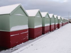 Row of beach huts covered with snow